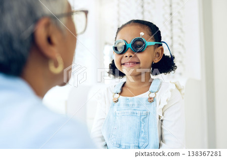 Vision, glasses or eye test with a girl and optician in an eyewear store for prescription frame lenses. Medical, consulting or spectacles with a young child and woman optometrist in an office Vision, glasses or eye test with a girl and optician in an eyewear store for prescription frame lenses. Medical, consulting or spectacles with a young child and woman optometrist in an office 138367281