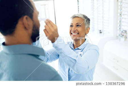 Woman optometrist, fitting and customer in store with consultation for helping health and vision. Happy client, optician and eye care equipment with appointment, prescription glasses and reading Woman optometrist, fitting and customer in store with consultation for helping health and vision. Happy client, optician and eye care equipment with appointment, prescription glasses and reading 138367296
