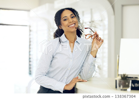 Glasses, optometrist smile and portrait of woman for vision healthcare, prescription product sales or ophthalmology. Eyeglasses, shop management and optician for eye care, eyesight support or eyewear Glasses, optometrist smile and portrait of woman for vision healthcare, prescription product sales or ophthalmology. Eyeglasses, shop management and optician for eye care, eyesight support or eyewear 138367304