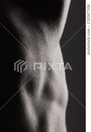 Fitness, man and torso with closeup in studio for wellness, stomach and body on dark background. Person, muscle or bodybuilder with six pack for healthy lifestyle and strength for abdomen or topless 138367306