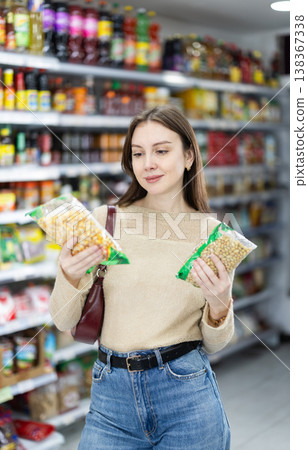 Girl in supermarket search and select product beans 138367338