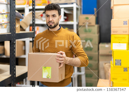 Worker loading box at warehouse store Worker loading box at warehouse store 138367347