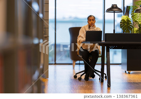 Student studying in modern library 138367361