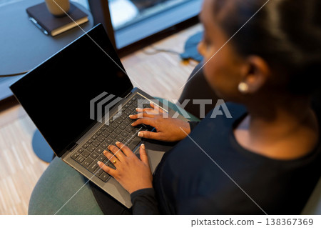 Woman working on a laptop computer 138367369