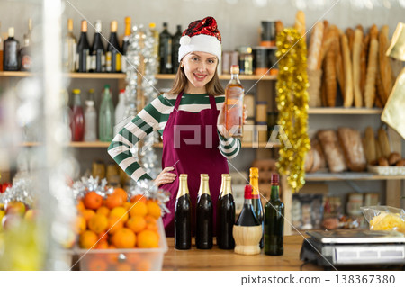 Female vendor in Santa Claus hat offers to buy wine and other products for the festive table on Christmas 138367380