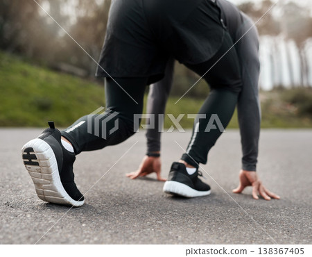 Fitness, starting position or runner on road with exercise, athletics or ready in performance routine. Begin, man or athlete with go preparation, crouch or cardio activity in outdoor training. 138367405