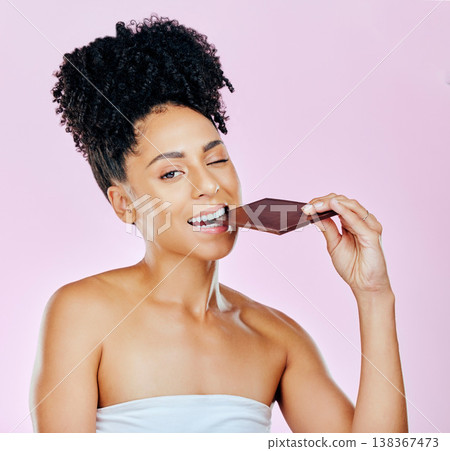 Portrait, sweet diet and woman with chocolate, eating and diabetes on a pink studio background. Face, person and model with unhealthy food, cacao treat and calories with sugar, nutrition and snack 138367473