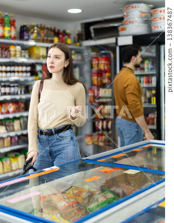 Female shopper are choosing something in food store 138367487