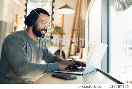 Man, remote work and laptop in cafe, headphones and productivity with freelancer and copywriter, writing article and blog. Workflow, typing on pc in coffee shop and copywriting with music or research 138367505