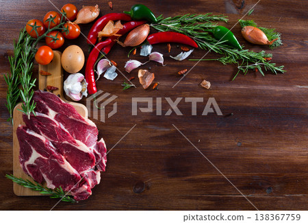 Raw beef and vegetables assortment on wooden desk, cooking ingredients Raw beef and vegetables assortment on wooden desk, cooking ingredients 138367759
