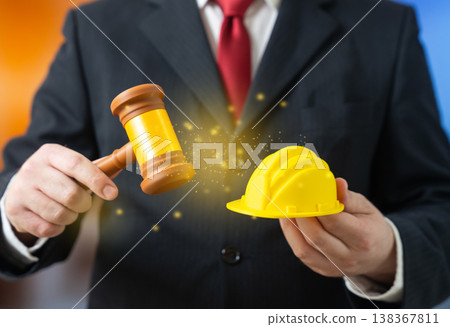A judge with a gavel and a yellow hard hat represents construction law. Permits and worker rights. Safety rules, compensation, and legal regulation ensure compliance and workplace protection A judge with a gavel and a yellow hard hat represents construction law. Permits and worker rights. Safety rules, compensation, and legal regulation ensure compliance and workplace protection 138367811