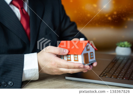 A businessman owns a house representing Real estate transactions. Buying and selling property. Valuation, notarization, and legal services support ownership transfer and secure deals A businessman owns a house representing Real estate transactions. Buying and selling property. Valuation, notarization, and legal services support ownership transfer and secure deals 138367826