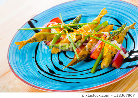 Battered anchovies with sauce and vegetables Battered anchovies with sauce and vegetables 138367907
