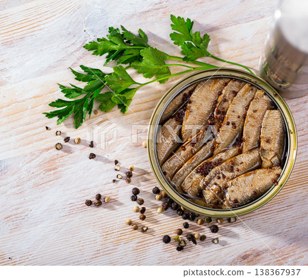 Small smoked sardines on background with greens and black pepper Small smoked sardines on background with greens and black pepper 138367937