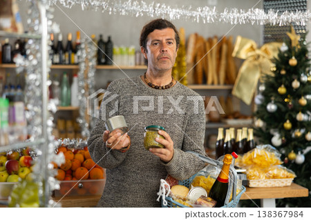 Shopper picking up reserved food while choosing snacks for Christmas festivities 138367984