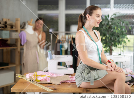 Young woman tailor designer is in sewing office 138368120