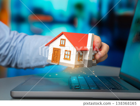 A house in the hands of a programmer symbolizes digital property management. Online bill payment and smart home control improve efficiency. Technology transforms household finance and automation. A house in the hands of a programmer symbolizes digital property management. Online bill payment and smart home control improve efficiency. Technology transforms household finance and automation. 138368165