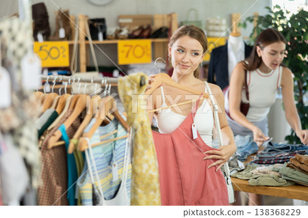 Young woman shopping for summer outfits in store 138368229