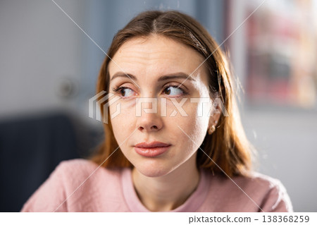 Portrait of a young woman performing a gymnastic exercise for the eyes Portrait of a young woman performing a gymnastic exercise for the eyes 138368259