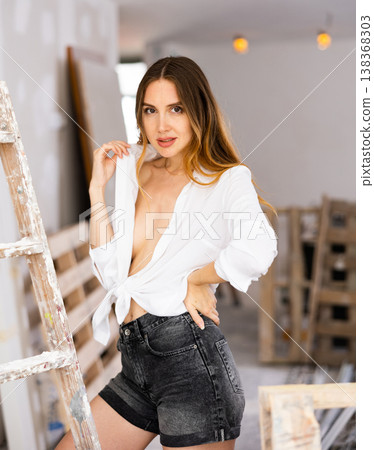 Seductive young woman poses in a revealing outfit 138368303