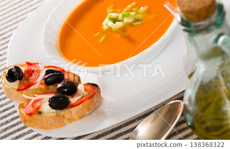Traditional cold soup gazpacho served with hot sandwiches 138368322