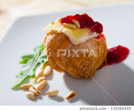 Camembert on mini croissant with jam, pine nuts 138368349