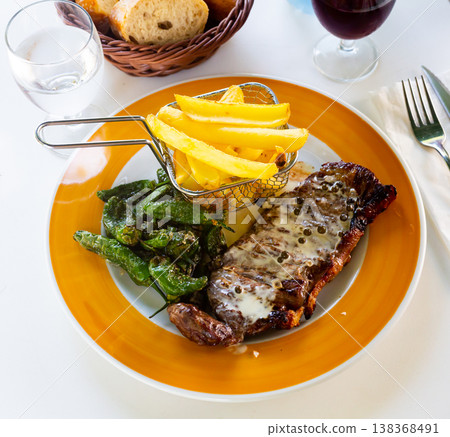 Plate of grilled beef and potatoes on table in restaurant, top view Plate of grilled beef and potatoes on table in restaurant, top view 138368491