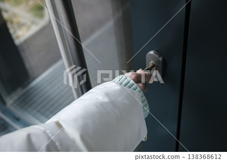 The close up of a hand holding a key in a door lock highlights routine safety, personal responsibility and the small rituals The close up of a hand holding a key in a door lock highlights routine safety, personal responsibility and the small rituals 138368612