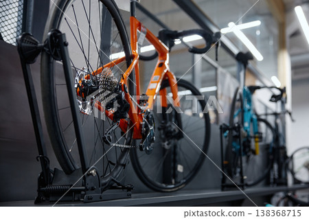 Modern retail space exhibits variety of vividly painted bicycles prepared for sale and testing Modern retail space exhibits variety of vividly painted bicycles prepared for sale and testing 138368715
