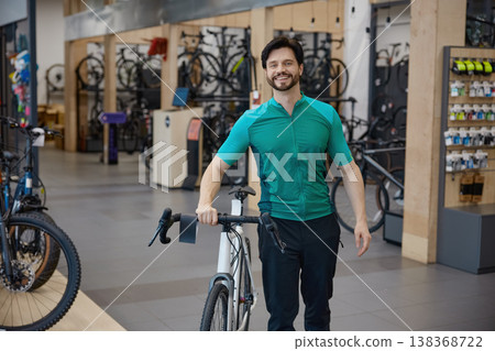 Enthusiastic bicycle expert guides amidst shop displays and gear Enthusiastic bicycle expert guides amidst shop displays and gear 138368722