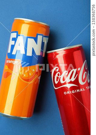 Mykolaiv, Ukraine - March 25, 2026: Can of Coca Cola Coke original taste with can of Fanta Original soft drink with orange juice on blue background. Mykolaiv, Ukraine - March 25, 2026: Can of Coca Cola Coke original taste with can of Fanta Original soft drink with orange juice on blue background. 138368756