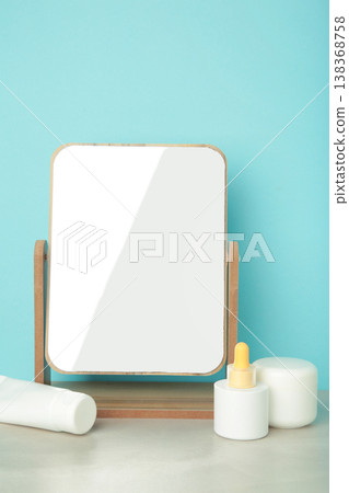 Set of various skincare products standing on table with stylish mirror. Vertical photo 138368758