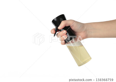 Hand holding oil glass sprayer for cooking isolated on white background. Space for text Hand holding oil glass sprayer for cooking isolated on white background. Space for text 138368759