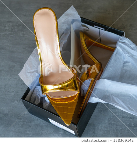 Elegant gold slip on shoes in box luxury fashion footwear stylish minimal still life composition 138369142