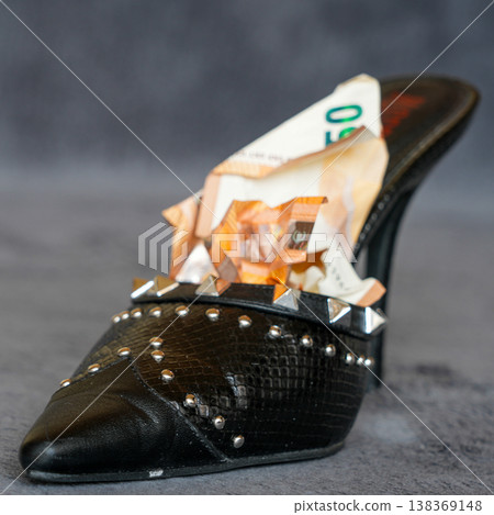 Black studded high heel shoe filled with euro banknotes luxury fashion concept wealth style 138369148