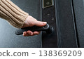 A woman opens a modern smart door lock with a digital keypad and biometric fingerprint access. 138369209