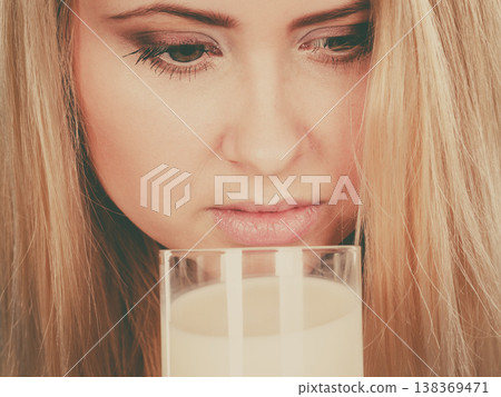 Woman drinking milk from glass Woman drinking milk from glass 138369471