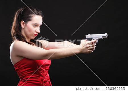 Sexy young woman - gun on black background 138369635