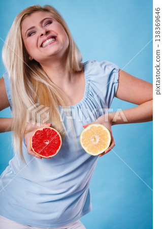 Woman holding red and green grapefruit Woman holding red and green grapefruit 138369646