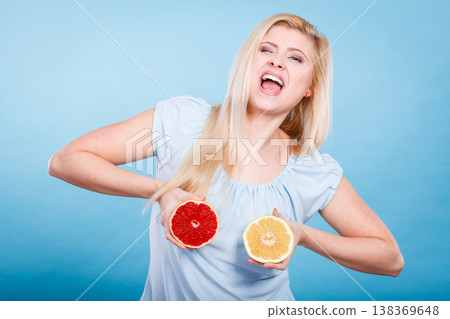 Woman holding red and green grapefruit Woman holding red and green grapefruit 138369648