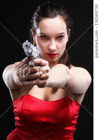 Sexy young woman - gun on black background 138369738