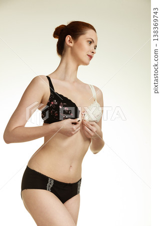 Girl of smooth body with brassiere dilemma. Girl of smooth body with brassiere dilemma. 138369743
