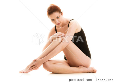 Sitting woman in underwear showing smooth legs Sitting woman in underwear showing smooth legs 138369767