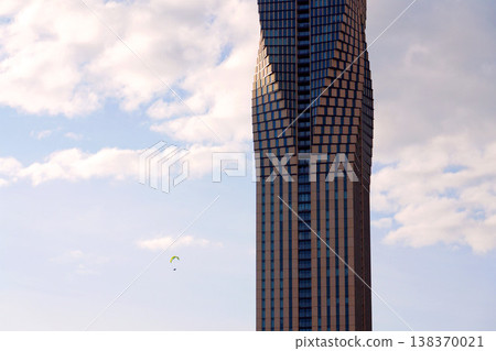 Paraglider with the tallest building in Scandinavia Karlatornet skycraper in Lindholmen, Gothenburg, Sweden, sunny day 138370021