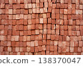 Stack of red bricks arranged end-on, close-up texture background for construction industry 138370047