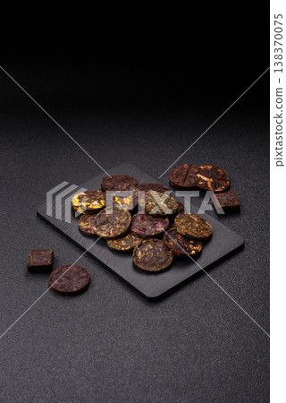 Organic Chinese green pu-erh tea with various herbs in round bricks. Chinese pu-erh tea Organic Chinese green pu-erh tea with various herbs in round bricks. Chinese pu-erh tea 138370075