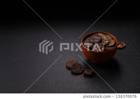Organic Chinese green pu-erh tea with various herbs in round bricks. Chinese pu-erh tea 138370076