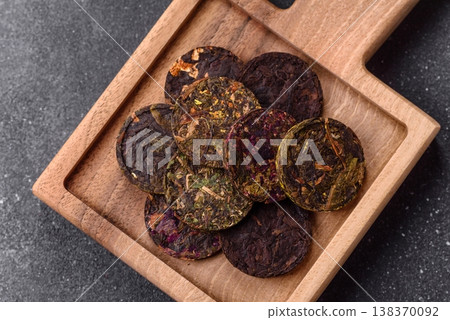 Organic Chinese green pu-erh tea with various herbs in round bricks. Chinese pu-erh tea 138370092