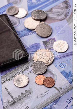 United Arab Emirates cash, dirhams and coins for exchange and financial transactions. UAE currency United Arab Emirates cash, dirhams and coins for exchange and financial transactions. UAE currency 138370127