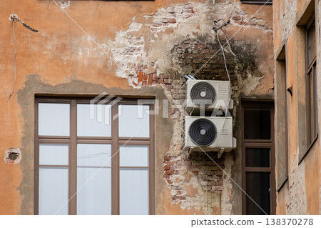 air conditioning on facade of building, air cooling in hot weather. air conditioning on facade of building, air cooling in hot weather. 138370278